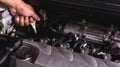 Hand of Mechanic technician service check level motor oil engine