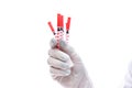 Hand in medical glove holding syringes isolated on white