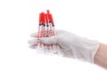 Hand in medical glove holding syringes isolated on white