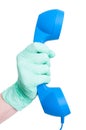 Hand with medical glove holding a vintage telephone receiver Royalty Free Stock Photo