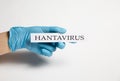 Hand in a medical glove holds a hantavirus tablet