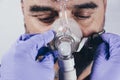 Man with respiratory mask for assisted breathing