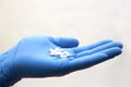 Hand in medical glove takes pill - choice medicine, coronavirus, covid19