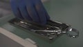 Hand in medical gloves takes dantist surgical instrument from box in clinic during stomatologic procedures