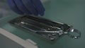 Hand in medical gloves takes dantist surgical instruments from tray in clinic during stomatologic procedures