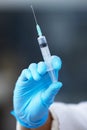 Hand, medical and syringe for vaccine, person and healthcare with cure, research and prevention. Closeup, doctor and Royalty Free Stock Photo