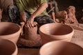 Hand of men working on the potter`s wheel. Hands sculpts a mortar from clay pot. clay ware handmade on the potter`s wheel at Royalty Free Stock Photo