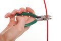Hand with metal nippers is cutting cable Royalty Free Stock Photo