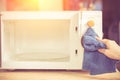 Hand with microfiber cleaning rag wiping inside of microwave oven, Royalty Free Stock Photo