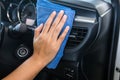 Hand with microfiber cloth cleaning Interior