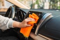 Hand with microfiber cloth cleaning seat, auto detailing and valeting concept, washing car care interior, selective focus Royalty Free Stock Photo