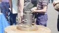 Hand minting of coins. Media. Roman minted coin held in hand after hammering process of minting - historical