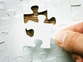 Hand with missing jigsaw puzzle piece. Business concept image for completing the final puzzle piece.