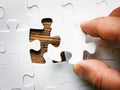 Hand with missing jigsaw puzzle piece. Business concept image for completing the final puzzle piece. Royalty Free Stock Photo