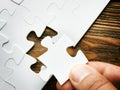 Hand with missing jigsaw puzzle piece. Business concept image for completing the final puzzle piece. Royalty Free Stock Photo