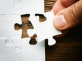 Hand with missing jigsaw puzzle piece. Business concept image for completing the final puzzle piece. Royalty Free Stock Photo