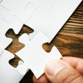 Hand with missing jigsaw puzzle piece. Business concept image for completing the final puzzle piece. Royalty Free Stock Photo