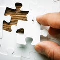 Hand with missing jigsaw puzzle piece. Business concept image for completing the final puzzle piece. Royalty Free Stock Photo