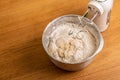 Hand mixer and a metal bowl with dough Royalty Free Stock Photo