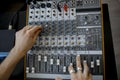 Hand on a mixer, operating the leader. Sound engineer working at mixing panel in the recording studio. Hands adjusting Royalty Free Stock Photo