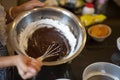 Hand mixing chocolate and flour using wire whisk