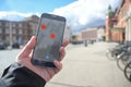 Hand with mobile phone and coronavirus tracking app via bluetooth against the spread of the pandemic, but controversial when it