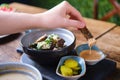 Hand moistens rye bread croutons in a juice, close up Royalty Free Stock Photo