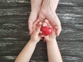 Hand mom and baby heart red on black wooden Royalty Free Stock Photo