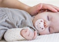 Hand of mother caressing her baby girl sleeping Royalty Free Stock Photo