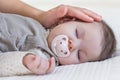 Hand of mother caressing her baby girl sleeping Royalty Free Stock Photo