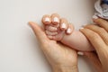 The hand of a mother and father close-up holds the fist of a newborn baby. Royalty Free Stock Photo