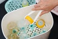 hand of mother feeding baby milk bottle into Steam sterilizer Royalty Free Stock Photo