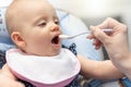 Hand of mother feeding her baby girl Royalty Free Stock Photo