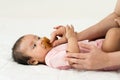 hand of mother gives a pacifier to her infant baby girl on bed Royalty Free Stock Photo