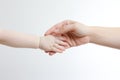 Hand of mother holding hand of daughter on white background, closeup, Newborn baby and mother holding hands on a white background Royalty Free Stock Photo