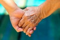 Hand in Hand, Mother holding hand of her daughter on bokeh blue swimming pool background, Asian body skin part, Symbol, Gesturing