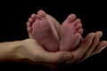 Hand of a mother holding tiny baby feet Royalty Free Stock Photo