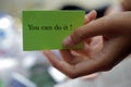 Hand with motivational notes on paper - You can do it. Self reminder and words of wisdom concept Royalty Free Stock Photo