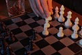 Hand moving pawn in fireside game of chess