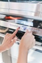 Hand moving the timer knob on oven