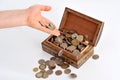 A hand moving to a case with coins