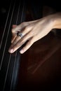 Hand of a musician playing on a contrabass closeup