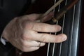 Hand of a musician playing on a contrabass closeup