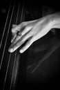 Hand of a musician playing on a contrabass closeup