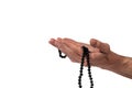 Hand of muslim man praying with rosary