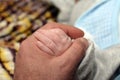 hand of a newborn baby in dadÃ¢â¬â¢s hand on a blurred background, Close up father's hand holding his new born baby Royalty Free Stock Photo