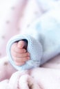 Hand of a newborn baby. Fingers of a newborn baby close up. Close-up lan hand of a newborn baby in a blue blouse not a Royalty Free Stock Photo