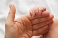 The hand of a newborn baby in the hands of mom Royalty Free Stock Photo