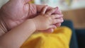 hand of a newborn baby. happy family toddler dream concept. father holding baby hand close-up. dad holding the hand of a Royalty Free Stock Photo