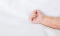 Hand of newborn baby with measles rash on white sheet Royalty Free Stock Photo